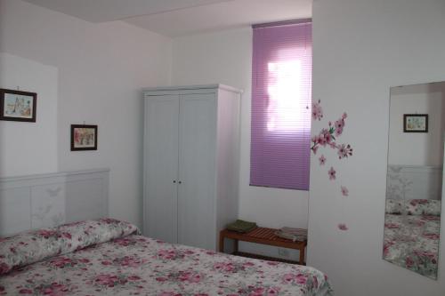 a bedroom with a bed and a purple window at Villa Lilly in Prima Porta