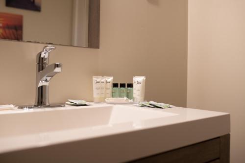 a white bathroom sink with a faucet at Ledges By the Bay in Rockport