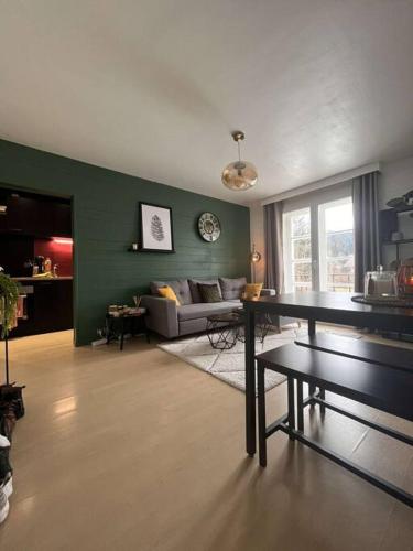 un salon avec un canapé et une table dans l'établissement Paisible F2 Ensoleillé Vue Lac, à Gérardmer