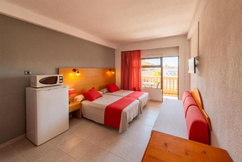 a hotel room with a bed and a balcony at Apartamentos Isla Del Sol in Can Pastilla