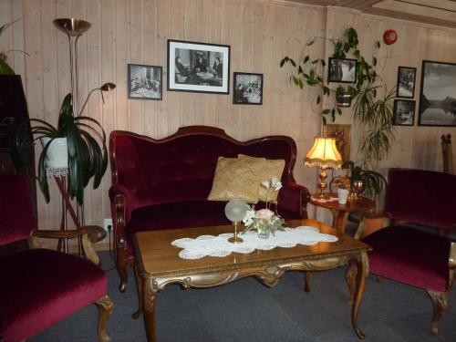 a living room with a couch and a coffee table at Eikum Hotel in Hafslo