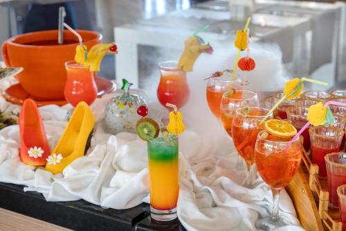 a table topped with glasses filled with different types of cocktails at Ramada Plaza Antalya in Antalya