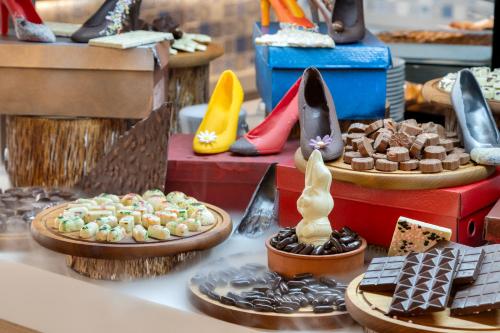 a display of different types of shoes and desserts at Ramada Plaza Antalya in Antalya
