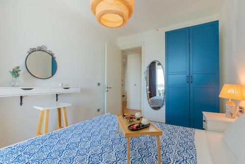 a bedroom with a blue bed and a table at Golden Stones House Sea And Lake View in Istanbul