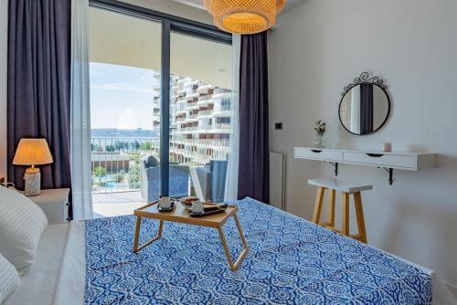 a bedroom with a bed with a table and a view at Golden Stones House Sea And Lake View in Istanbul
