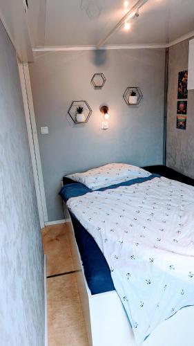 a bedroom with a large bed with blue sheets at Waterview - Schwimmendes Ferienhaus "Black Pearl" auf dem Wasser mit Blick zur Havel, inkl Boot zur Nutzung in Fürstenberg-Havel