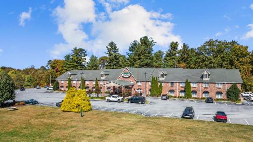 a large building with a parking lot in front of it at Mountain Inn & Suites Flat Rock in Flat Rock