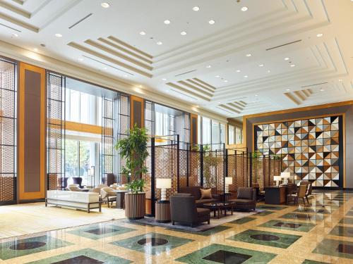 a lobby with chairs and tables and windows at Hotel The Celestine Tokyo Shiba in Tokyo