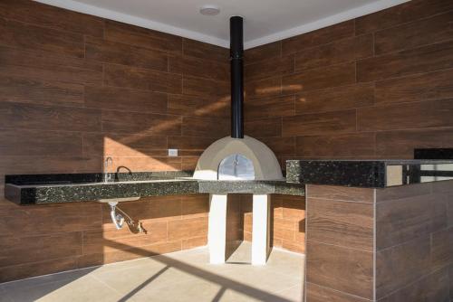 a kitchen with a counter and a sink in a room at Ubatuba North Shore in Ubatuba