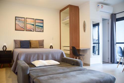 a bedroom with a bed and a chair and a couch at Ubatuba North Shore in Ubatuba