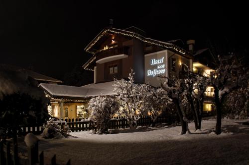un hotel nella neve di notte di Hotel Belfiore a Monclassico