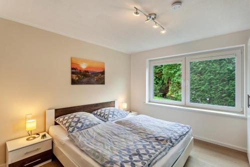 a bedroom with a bed and a window at Ferienwohnung Kleine Auszeit in Schmallenberg