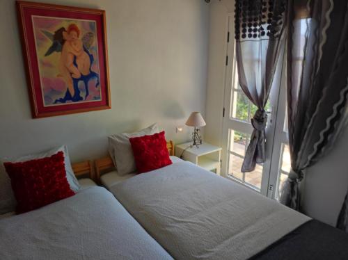 1 dormitorio con 2 camas individuales y ventana en La Casita, en Agulo