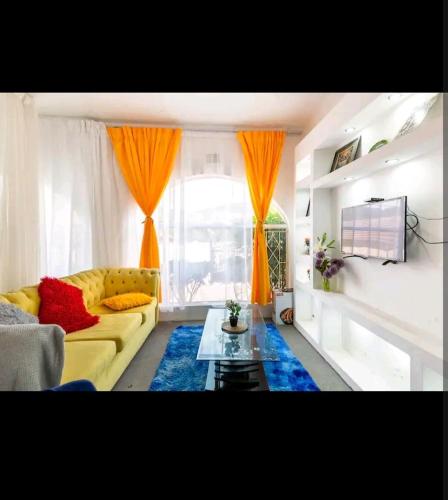 a living room with a yellow couch and orange curtains at Dungar-Hill accommodation in Johannesburg