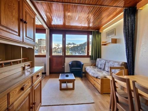 a living room with a couch and a table at Appartement La Plagne, 3 pièces, 8 personnes - FR-1-455-45 in La Plagne