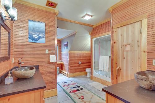 a bathroom with two sinks on a wooden wall at Ski-In and Ski-Out Townhome in Jay Peak Ski Resort! in Jay