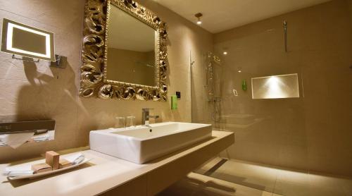 a bathroom with a white sink and a mirror at Albergo Losone in Losone