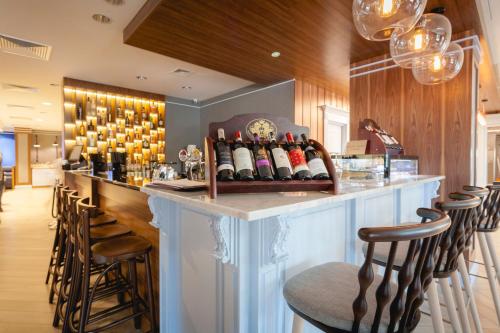a bar with a bunch of bottles of wine at Flatbook - City Center SPA Apartments Dwie Motlawy in Gdańsk