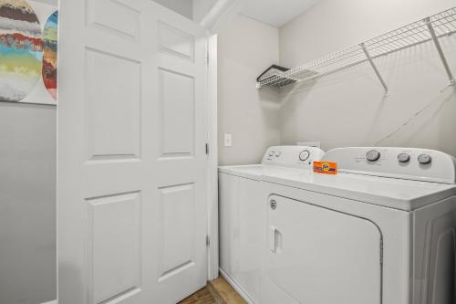 a white laundry room with a washer and dryer at Alohalani at Surfside Beach in Myrtle Beach