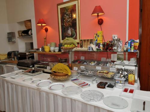 a table with plates of food on it in a kitchen at Hotel Haus Am Meer Cavtat in Cavtat