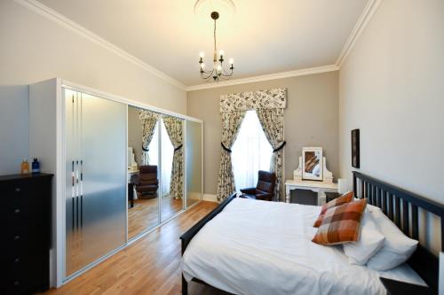 a bedroom with a bed and a living room at Pladda View in Ayr