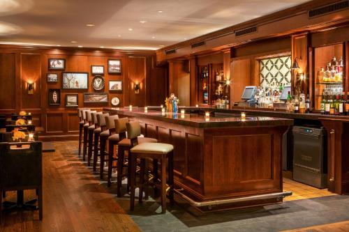 a bar with chairs and a bar counter at Equinox Resort Residences in Manchester