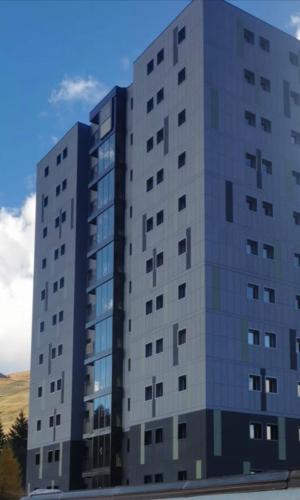 a large white building with windows on the side of it at ROYAL SUITE TOTTO'NETTA 504 in Passo del Tonale