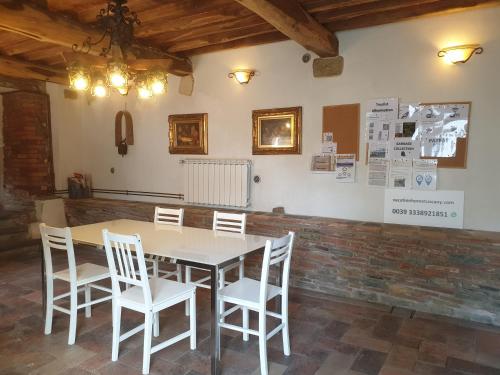 a dining room with a table and white chairs at Vacation Home Tuscany Filettole 2 in Filettole