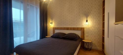 Ένα ή περισσότερα κρεβάτια σε δωμάτιο στο Ozimska77