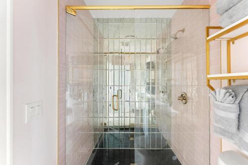 a bathroom with a shower with pink tiles at The Acoma House in Denver