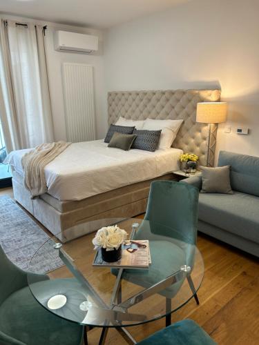 a bedroom with a bed and a table and a couch at Atelier 35 Studio in Zagreb