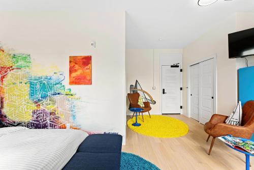 a bedroom with a bed and a painting on the wall at The Acoma House in Denver