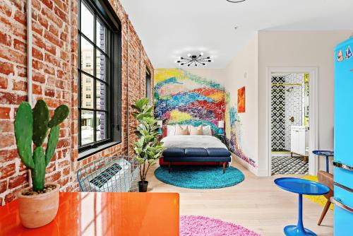 a bedroom with a bed in a brick wall at The Acoma House in Denver