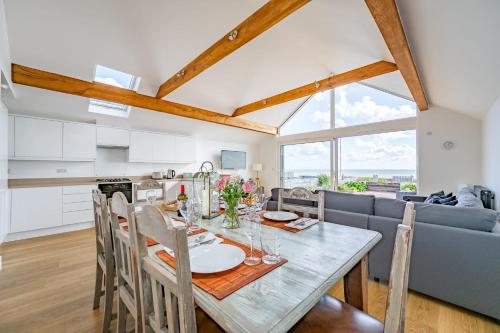 a kitchen and dining room with a table and chairs at Fisherman's Croft Your Dream Getaway Awaits in Pevensey