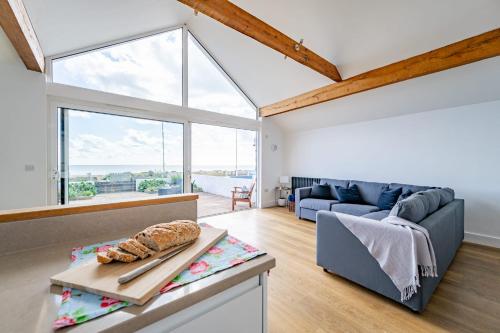 a living room with a large window and a couch at Fisherman's Croft Your Dream Getaway Awaits in Pevensey