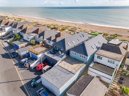 an aerial view of a row of houses next to the beach at Fisherman's Croft Your Dream Getaway Awaits in Pevensey