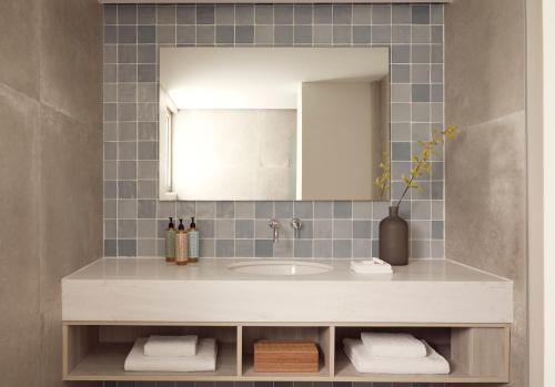a bathroom with a sink and a mirror at Mare Paphos in Paphos