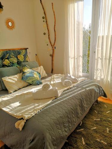 a bedroom with a large bed with a window at Comme une Envie d'air FORET in Guémy