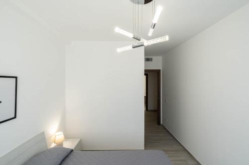 a bedroom with a bed and a white wall at Dimora Rosselli - Apartments in Fasano