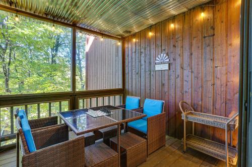 a screened in porch with a table and chairs at Mountain Creek Resort Summer Condo with Deck in Vernon Township
