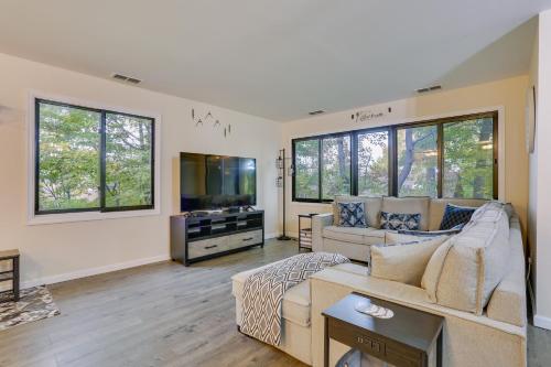 a living room with a couch and a flat screen tv at Mountain Creek Resort Summer Condo with Deck in Vernon Township
