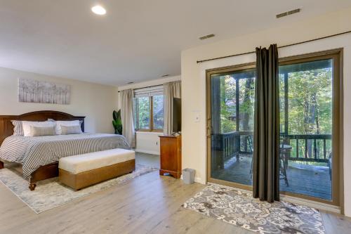 a bedroom with a bed and a sliding glass door at Modern Vernon Township Condo Near Ski and Water Park in Vernon Township
