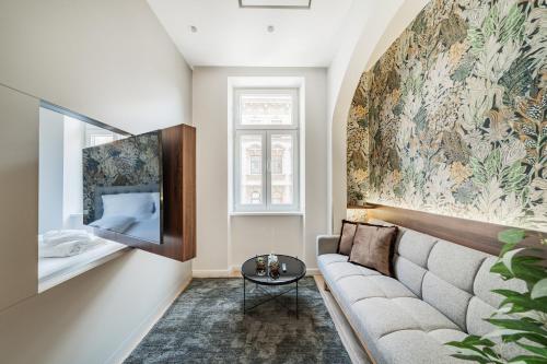 a living room with a couch and a wall mural at Zeus Design Apartments Schönbrunn in Vienna