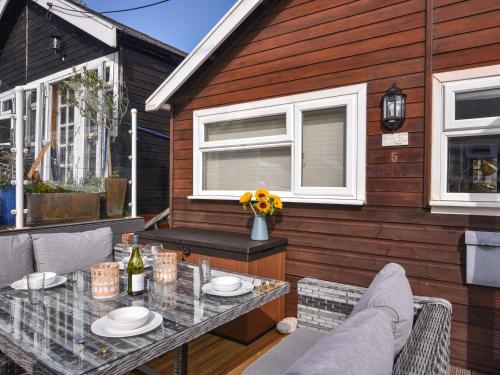 a patio with a table and chairs and a building at Marnie's Rest in Lyme Regis