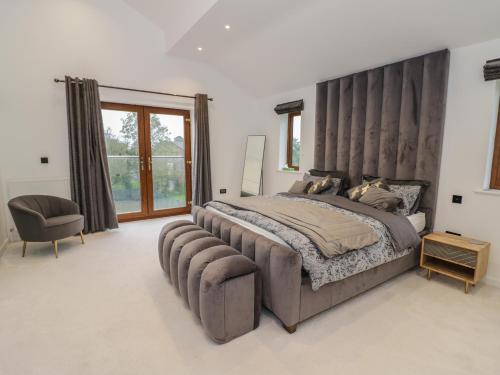 una grande camera da letto con un grande letto e una sedia di 85A Braybrooke Road a Kettering