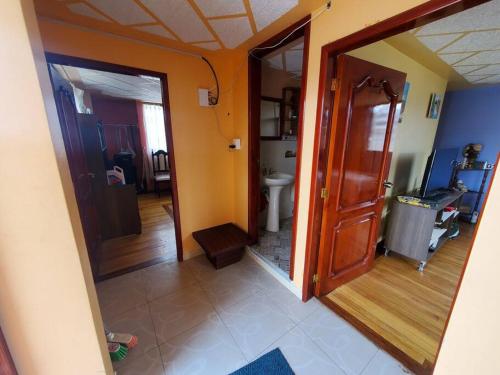a hallway of a house with a bathroom and a toilet at Suite Hostal El Trébol 2 habitaciones in Latacunga