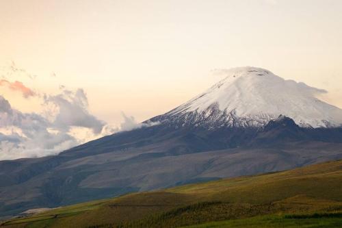 a snow covered mountain on top of a hill at Suite Hostal El Trébol 2 habitaciones in Latacunga