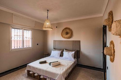 a bedroom with a bed with white sheets and pillows at Central Majorelle Apartment Sleeps 4 in Marrakesh