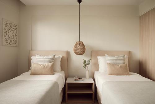 two beds sitting next to each other in a room at Mare Paphos in Paphos