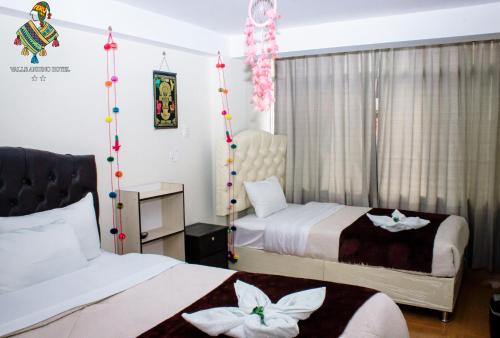 a hotel room with two beds with flowers on them at ANDEAN VALLEY HOTEL in Cusco